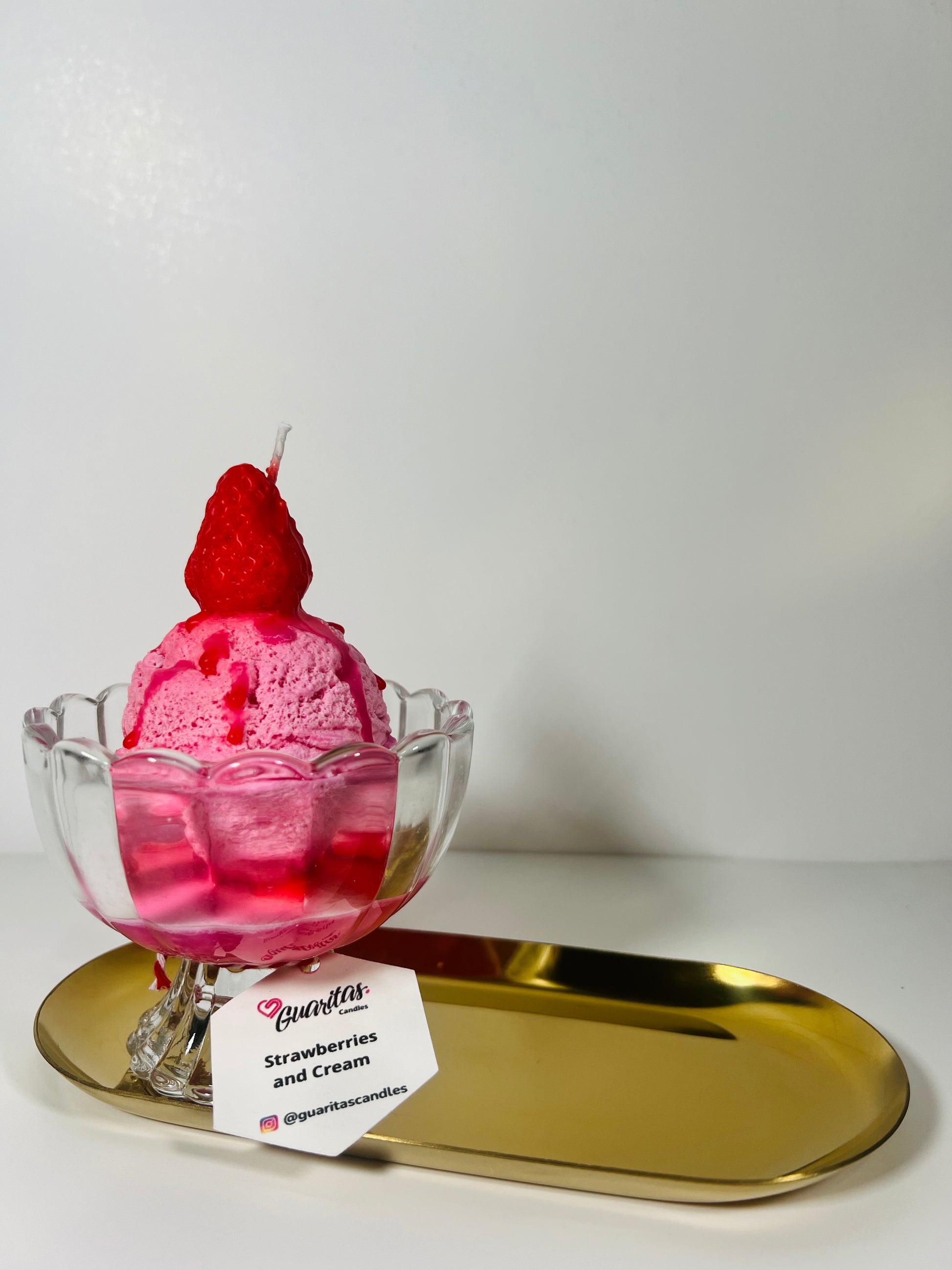 Strawberry ball ice cream candle with topping and strawberry syrup