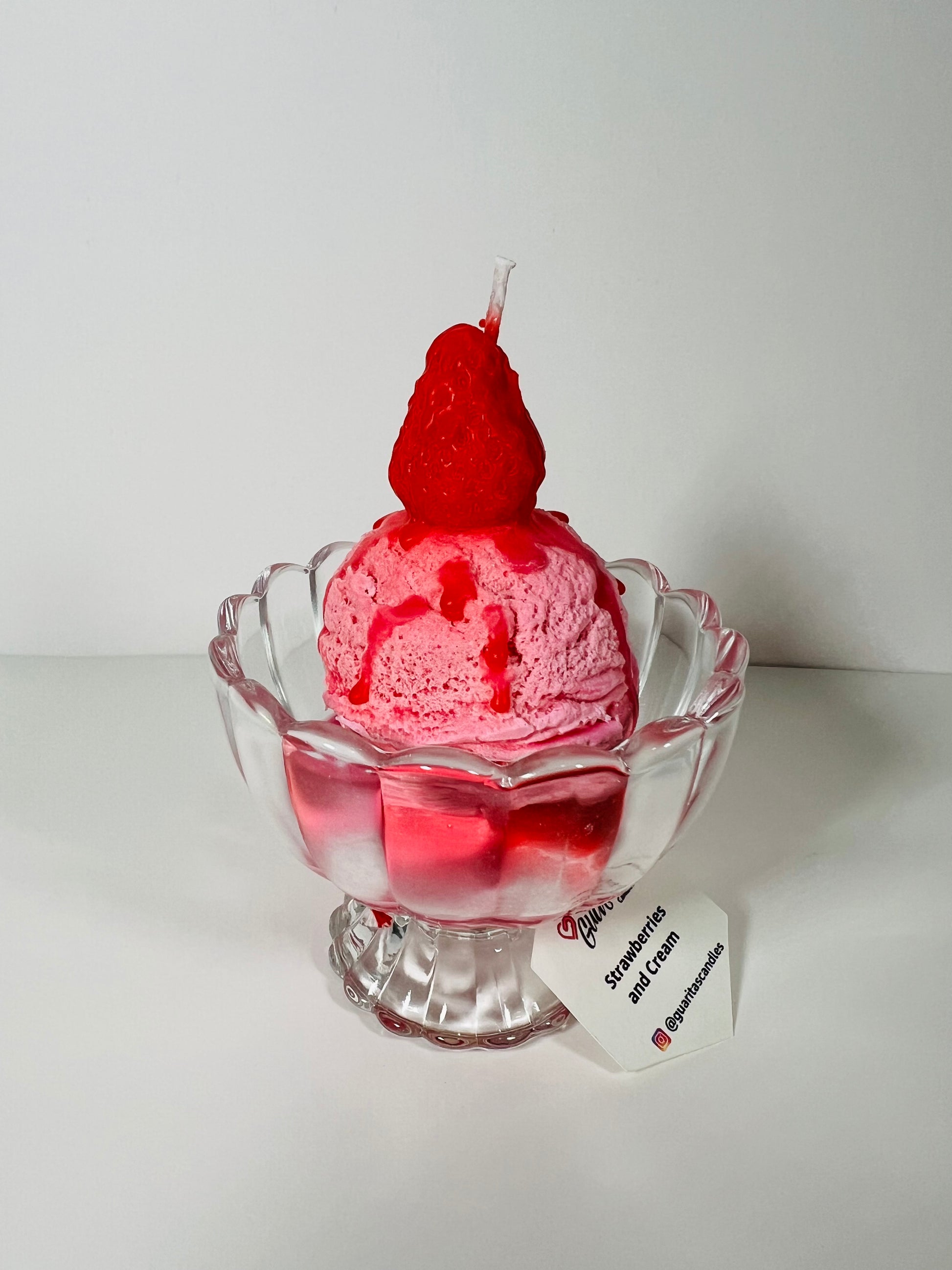 Strawberry ball ice cream candle with topping and strawberry syrup