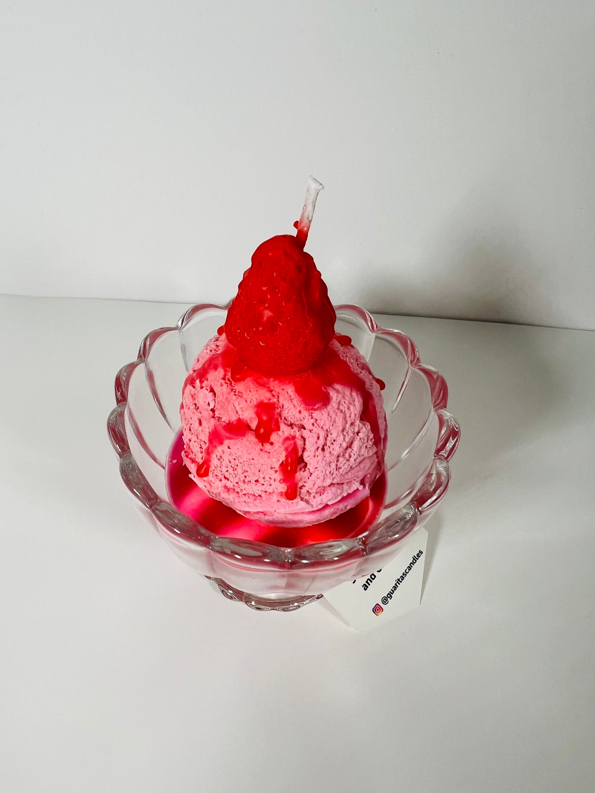 Strawberry ball ice cream candle with topping and strawberry syrup