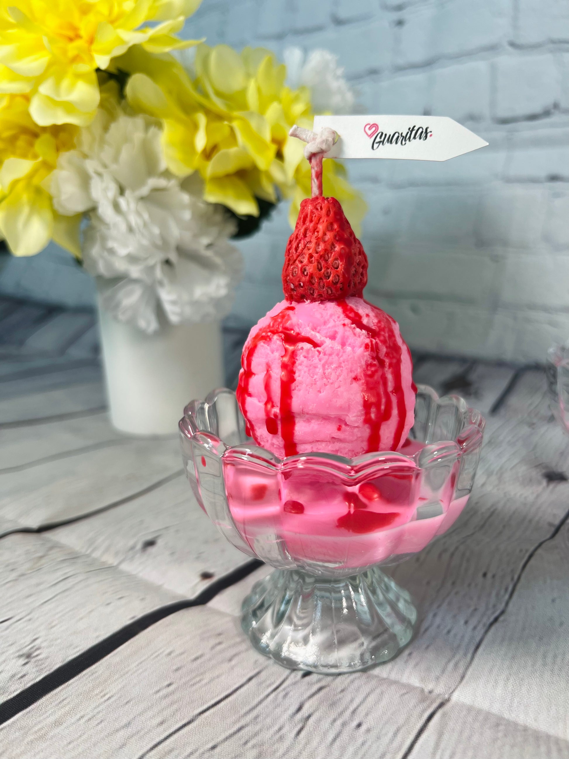 Strawberry ball ice cream candle with topping and strawberry syrup