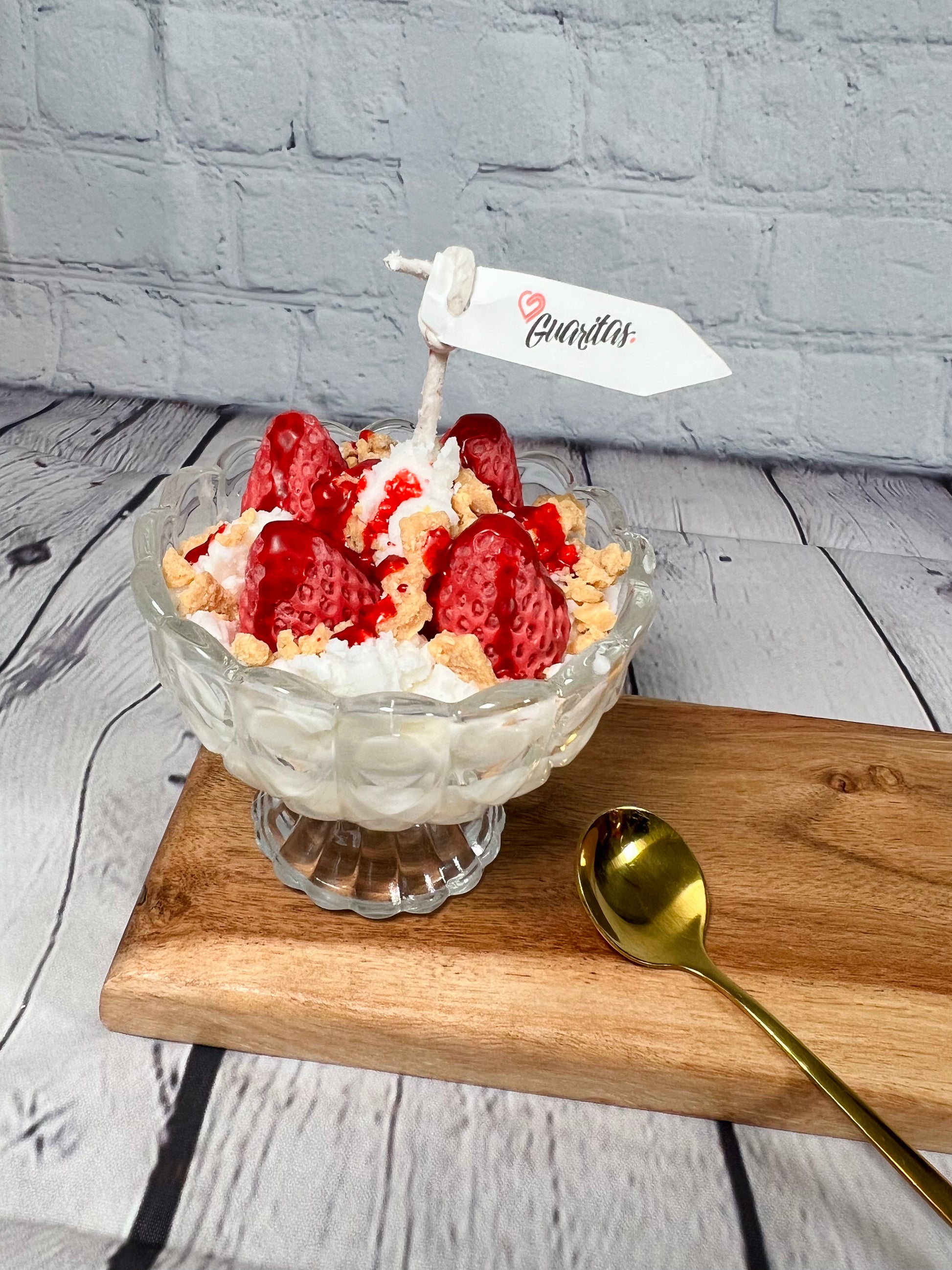 Ice cream candle in cup strawberries with creams and cake